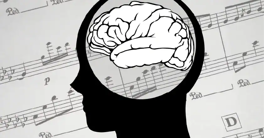 Silhouette of a human head with a brain inside, set against a background of musical notes and sheet music.