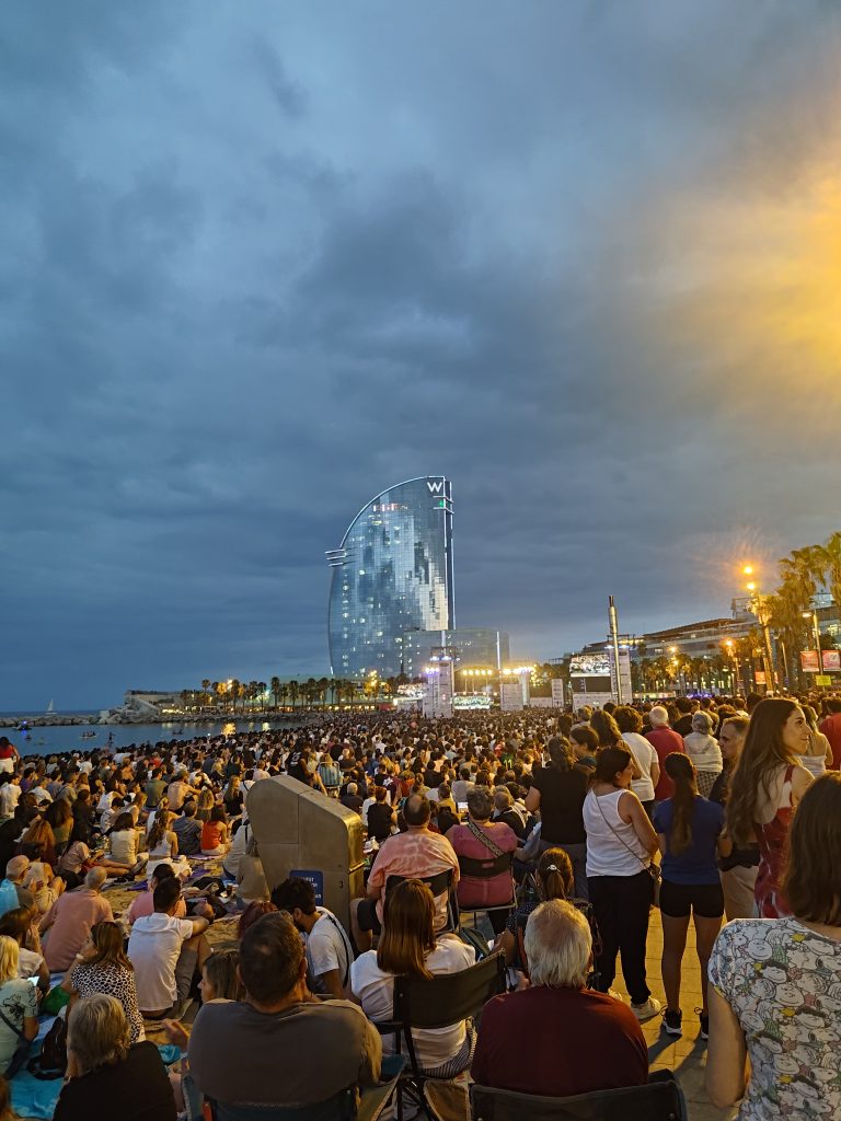 Crowd at an open-air summer concert on the Barceloneta seafront in Barcelona