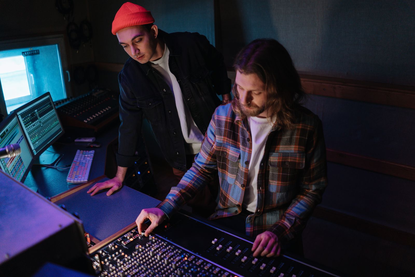 Music royalties explained: an artist and a producer working at a mixing console in a recording studio